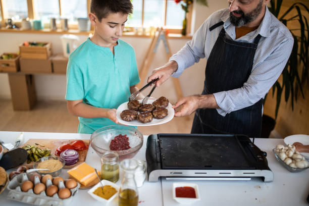 istock He's always happy to help dad in the kitchen 1186928411