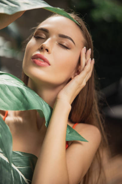 istock Pretty young woman touching the face with a hand 1186929849