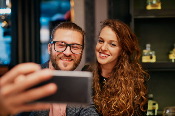 istock Couple taking selfie in restaurant. 1186930242