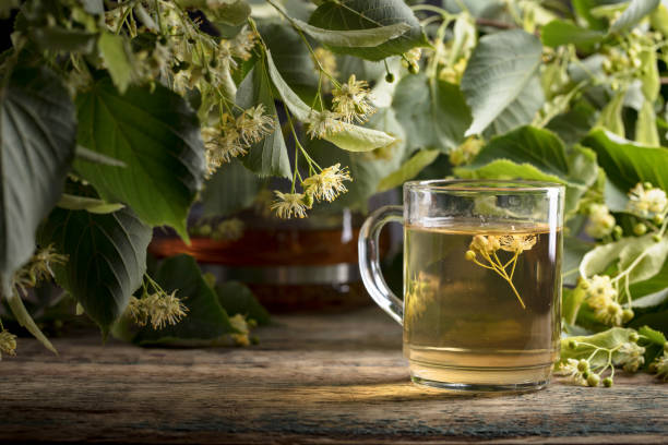 istock Linden tea and flowers on wooden table. 1186930244