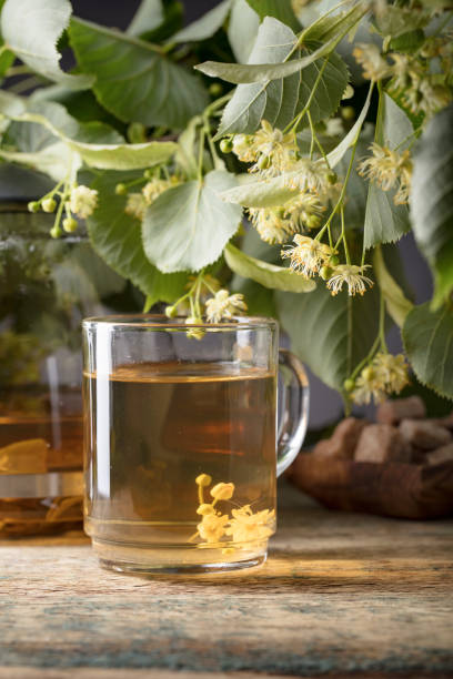 istock Linden tea and flowers on wooden table. 1186930245