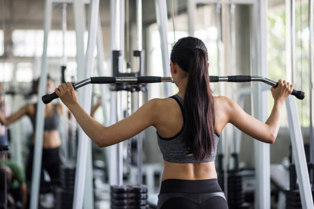 istock Woman pump back muscles exercise in gym 1186930460