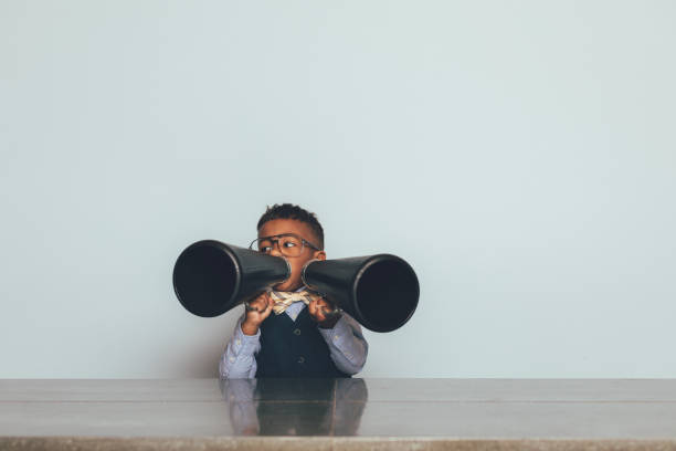 istock Young Nerd Boy with Two Megaphones 1186931732