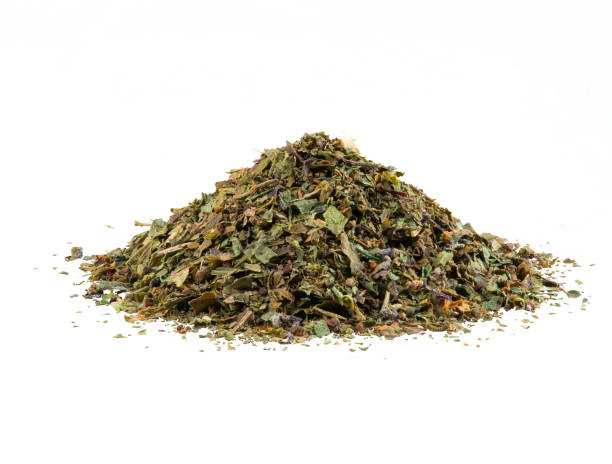 istock Some chopped, mixed herbs isolated on white background with copy space for text, images. Spices. Packaging concept. Close-up, side view 1186931852