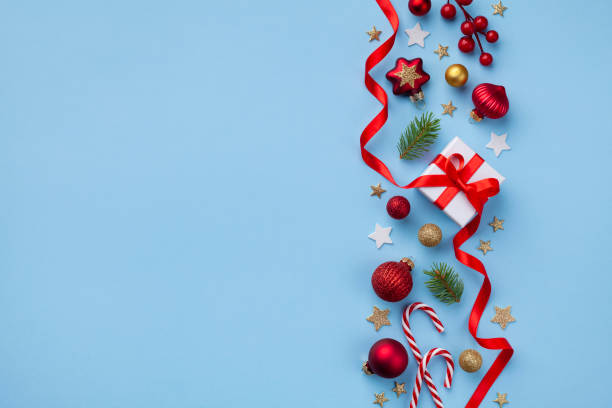 istock Gift or present box and holiday decorations on light blue background top view. Christmas or New year greeting card. Flat lay. 1186934875