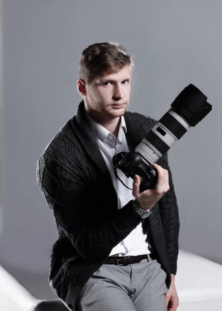 istock creative photographer sitting on an office chair.isolated on grey background 1186935735