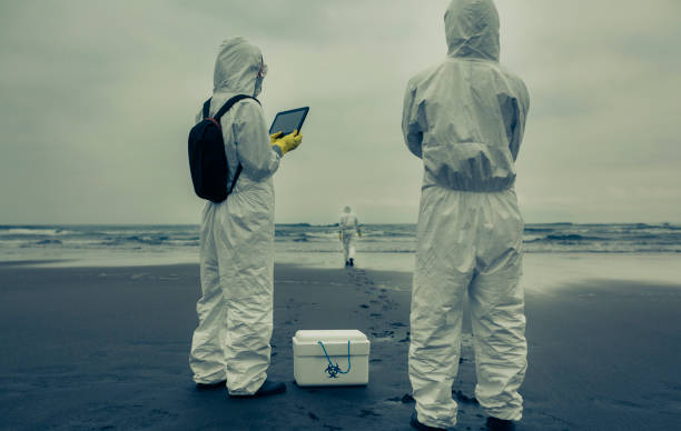 People with bacteriological protection suits looking for evidence at sea Unrecognizable people with bacteriological protection suits looking for evidence at sea backwards picture search stock pictures, royalty-free photos & images