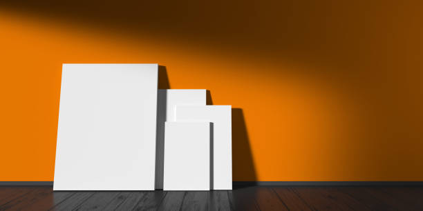 istock blank white vertical picture frames on the orange loft wall 1186937523
