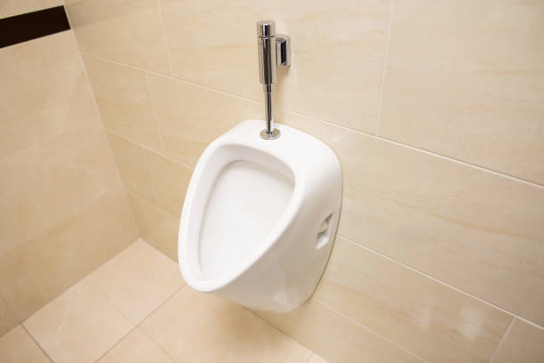 istock Modern stylish male urinal on the wall. Beautiful brown ceramic tile, copy space 1186937680