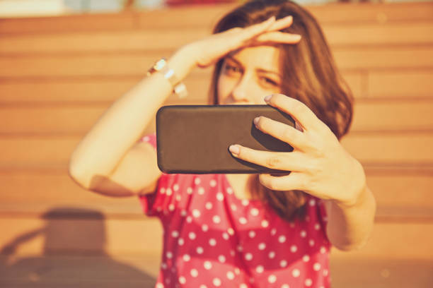 istock Beautiful woman using cellphone outdoors. Focus on hands. 1186939308