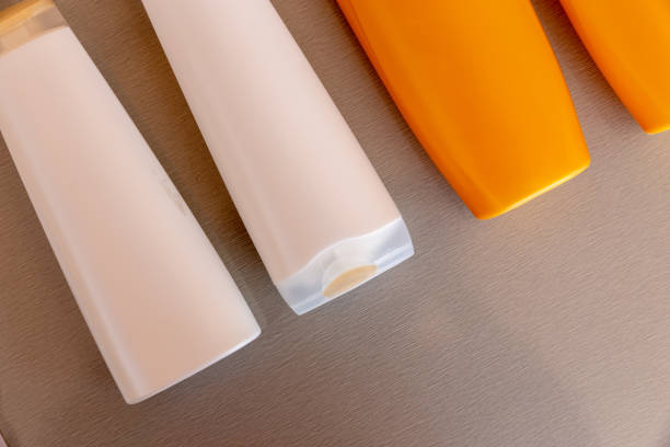 istock Orange and white shampoo bottles on wooden table background. reuse plastic. 1186942431
