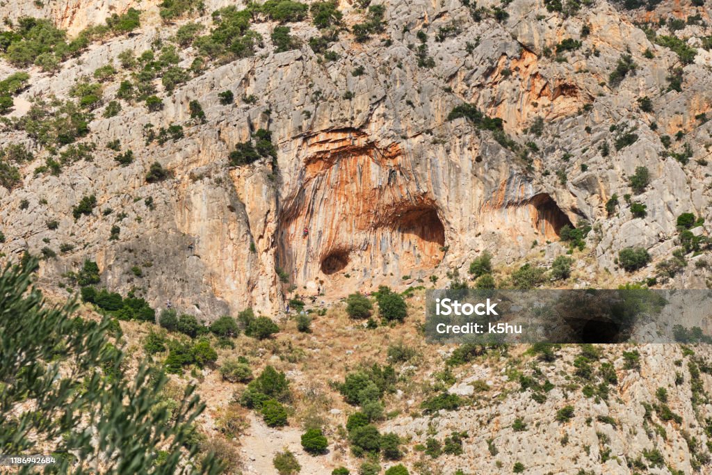 Twin Caves climbing sector in Leonidio, Arcadia, Peloponnese, Greece, with red limestone rock. Clambering Stock Photo