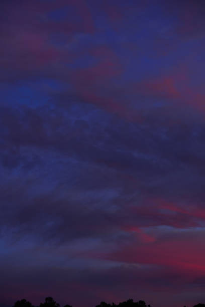 istock Wispy clouds just before dawn, catching the first rays of subtle orange sunlight 1186944180