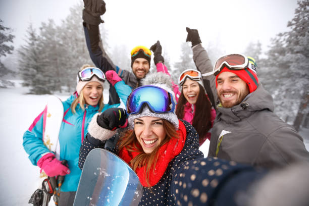 istock Friends with hands up on skiing 1186945175
