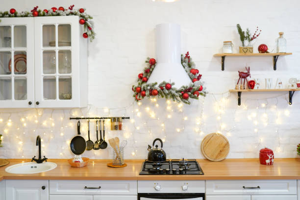 winter kitchen with red decorations, christmas cooking table and utensils winter kitchen with red decorations, christmas cooking table and utensils red kitchen cabinets stock pictures, royalty-free photos & images