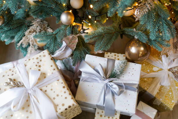 istock Stacks of Christmas presents under a Christmas tree 1186945305