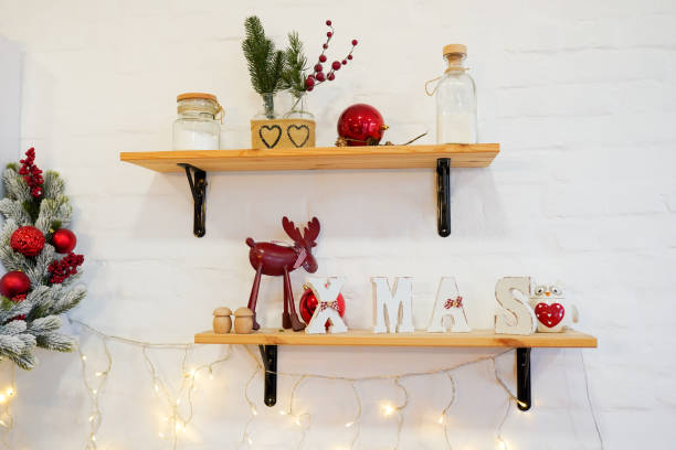 istock Kitchen cooking utensils in ceramic storage pot and Christmas decor on a shelfs 1186945330