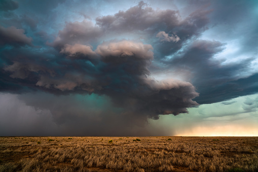 A supercell thunderstorm with dramatic storm clouds approaches Dexter, New Mexico during a severe weather outbreak.