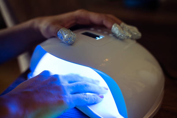 istock Woman using UV light dryer. Manicure, spa salon concept 1186949330