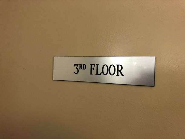 A sign for the third floor of a building