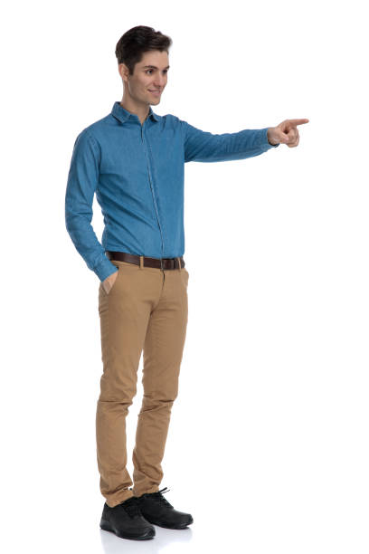 istock happy young model pointing finger and smiling 1186952463