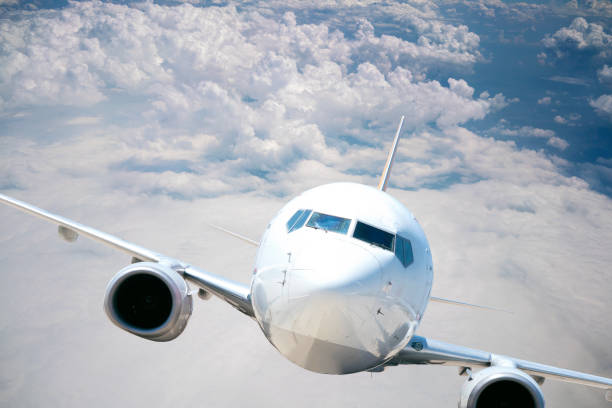 istock Commercial airplane flying above clouds 1186952971