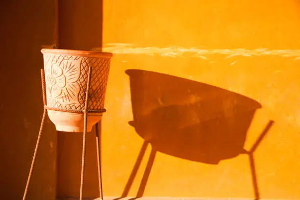Terracotta Flower Pot Casting a Long Shadow on Orange Rendered Walls in El Gouna Egypt