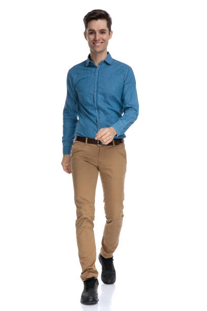 istock happy smart casual man walking and smiling 1186953470
