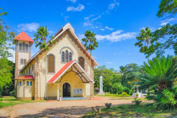 Church of St. Anne's Church of St. Anne's Bay, PRASLIN, Seychelles The Roman Catholic Church in the Bay "Baie Ste. Anne "finds the visitor near the main road, it is located in a beautiful area with a grotto of Mary and a statue. The church was founded in 1853, the church was inaugurated in April 1945 and blessed by Olivier Maradan. Baie Sainte Anne is an administrative district of Seychelles located mostly on the island of Praslin, but also administers Curieuse Island and some other smaller islands. Praslin is the second largest island of the Seychelles. Praslin has a population of around 7,533 people and comprises two administrative districts: Baie Sainte Anne and Grand' Anse. The main settlements are the Baie Ste Anne, Anse Volbert and Grand' Anse. praslin island stock pictures, royalty-free photos & images