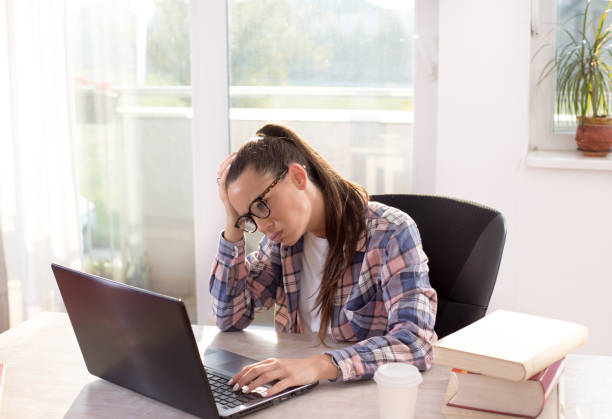 istock Tired student girl with laptop 1186955896