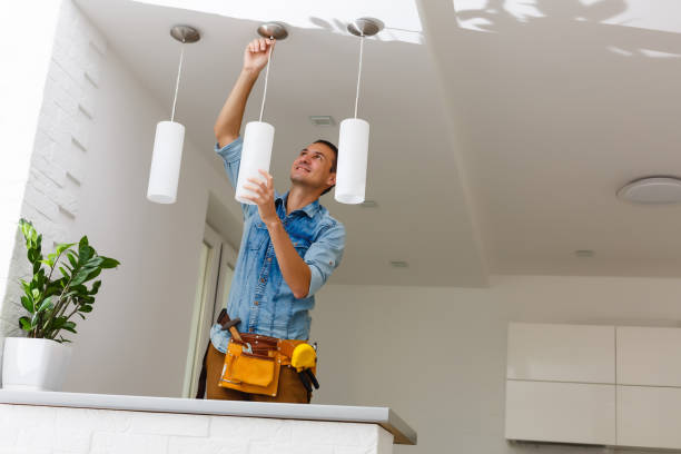 Portrait Of A Male Electrician Fixing Light On Ceiling Portrait Of A Male Electrician Fixing Light On Ceiling repairman photos stock pictures, royalty-free photos & images