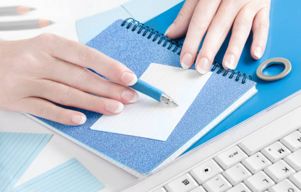 istock Female hands and ball pen with paper 1186957294
