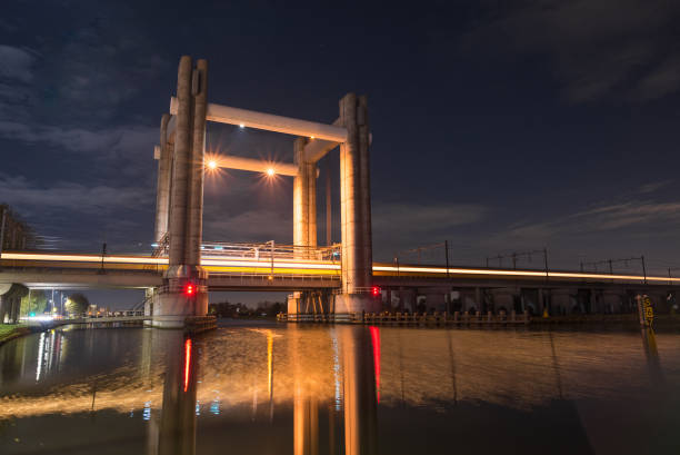 istock Train passes by at high speed on a railway lifting bridge over a river in Holland 1186957364