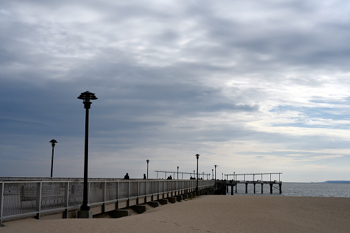 The pier and beach opposite the Coney Island Parachute Jump on a chilly and overcast Sunday in November.