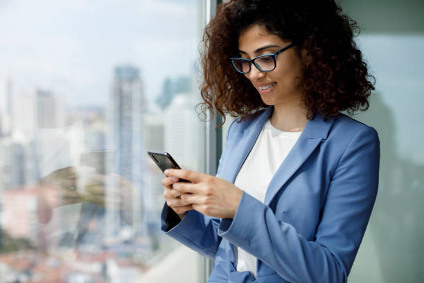 istock Young businesswoman using smart phone 1186957465