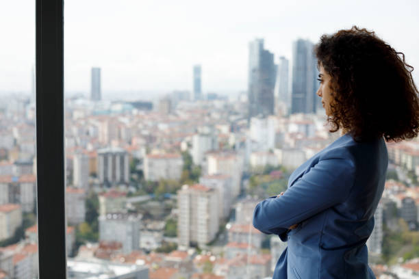 istock Thoughtful businesswoman looking through window 1186957466