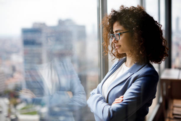 istock Thoughtful businesswoman looking through window 1186957467