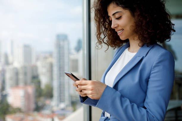 istock Young businesswoman using smart phone 1186957508