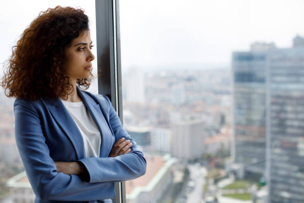 istock Thoughtful businesswoman looking through window 1186957565