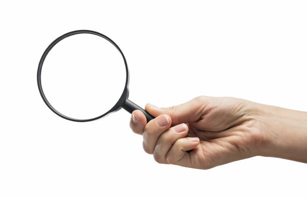 istock Magnifying glass in woman hand. 1186957568