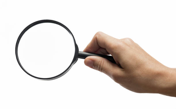 istock Magnifying glass in woman hand. 1186957585