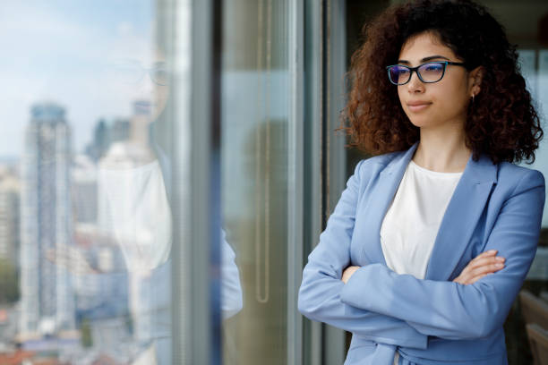 istock Young thoughtful businesswoman looking through window 1186957599