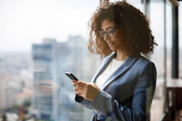 istock Young businesswoman using smart phone 1186957655