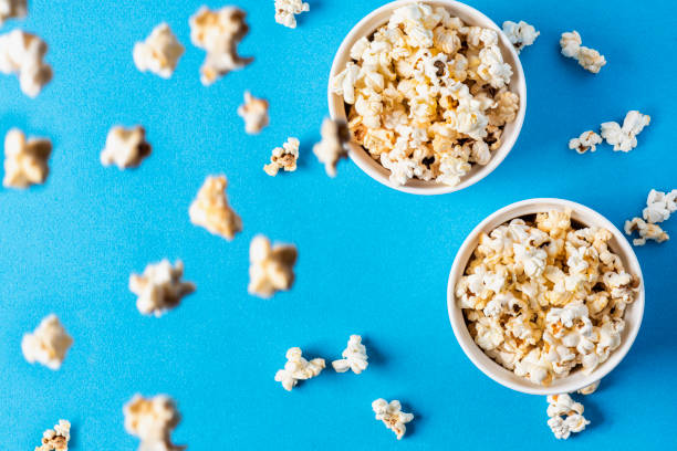 istock Two white bowls with popcron on a blue background 1186957925