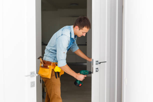 istock Master with screwdriver installs door hinges. 1186958895