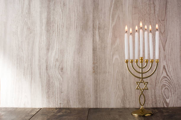 Jewish Hanukkah menorah on wooden background
