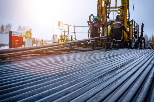 istock Oil Drill pipe. Rusty drill pipes were drilled in the well section. Downhole drilling rig. Laying the pipe on the deck. View of the shell of drill pipes laid in courtyard of the oil and gas warehouse. 1186963119