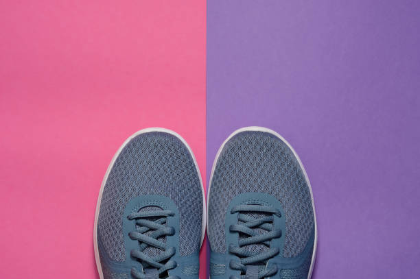 istock Sport sneakers on pink purple background with copy space for text. Sport objects background. Sports concept 1186964780
