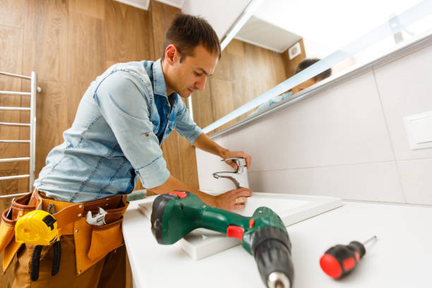 istock Handsome professional plumber doing sink reparation. Contractor. 1186965683