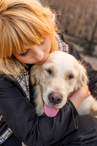 istock blond woman hugging her retriever dog 1186967460